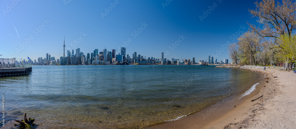 Fototapeta premium Sandy lakeshore with Toronto skyline and CN Tower in the distance