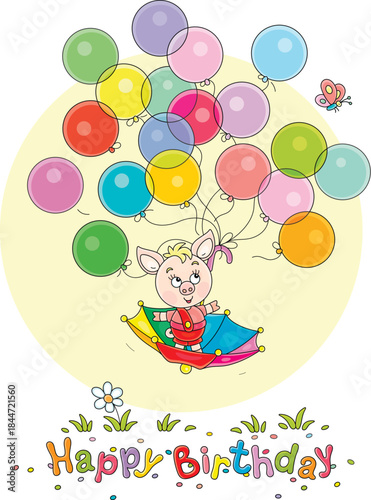 Birthday card with a funny cartoony little piglet flying in an umbrella with colorful toy balloons and merry butterfly over a green summer lawn, vector cartoon illustration