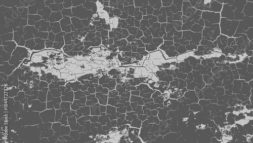 Close up abstract texture of cracked and peeling grey paint on a wall