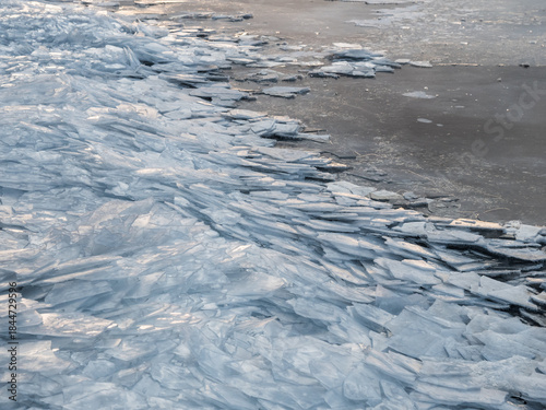 Layers of cracked ice on lakeside