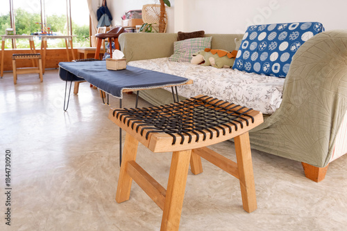 Photography Wooden stool with woven rope seat in cozy living room