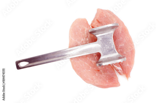 Metal meat hummer and two Pork Chops isolated on white background. Cooking Pork meat. Piece of pork loin for chipping. Close-up. 