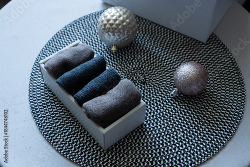 Cozy holiday gift with folded textiles and Christmas ornaments