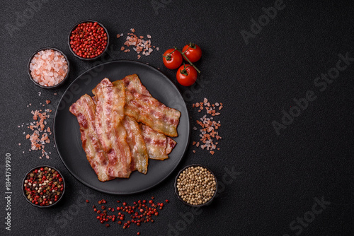 Canvas Print Fried smoked bacon slices, ham, jamon, or prosciutto strips for cooking
