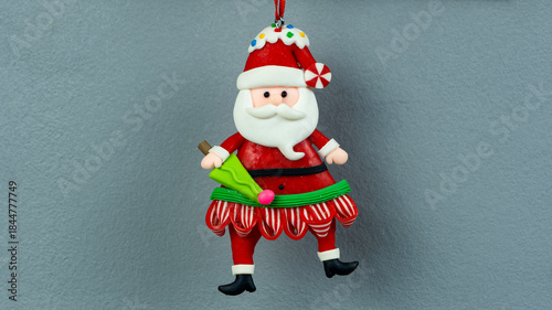 Santa Claus clay figure on gray background. Handmade Christmas tree decoration