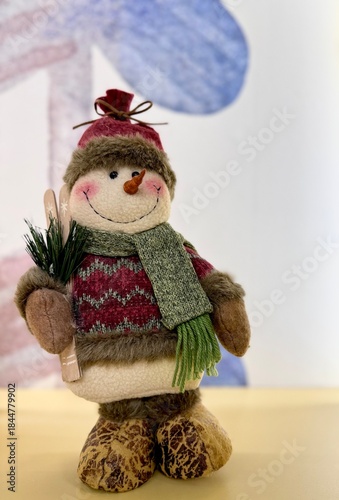 Cute plush snowman toy with soft texture and friendly expression. Cozy winter character, seasonal decor element, festive mood. Isolated, minimal background, soft light