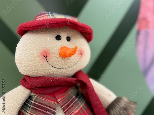 Cute plush snowman toy with soft texture and friendly expression. Cozy winter character, seasonal decor element, festive mood. Isolated, minimal background, soft light