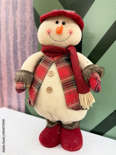 Cute plush snowman toy with soft texture and friendly expression. Cozy winter character, seasonal decor element, festive mood. Isolated, minimal background, soft light