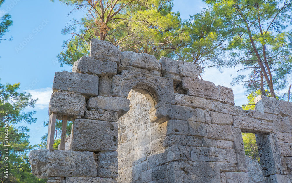 Naklejka premium Stone ruins of houses and the street of the ancient city of Phaselis, Faselis, - the city of ancient Lycia, in the territory of modern Turkey, Antalya.