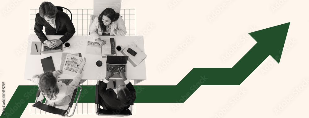 Fototapeta premium A business team works together around a table, analyzing charts and data on laptops. The atmosphere is focused and collaborative, aiming to increase company growth.