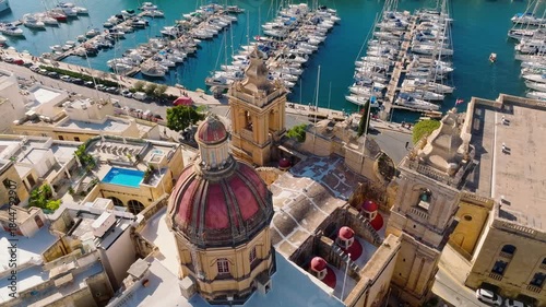 Drone view of old Birgu city and church dome. Marina, yachts. Malta island