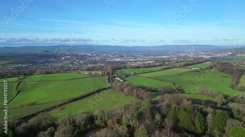 Coffinswell, South Devon, England: DRONE VIEWS: The drone flies over farmland heading towards the market town of Newton Abbot. UK green belt land is increasingly under threat from urban development.