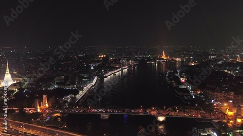 Aerial view of Wat Prayurawongsawas Warawihan pagoda and Phra Pokklao bridge, Bangkok, Thailand, 4k