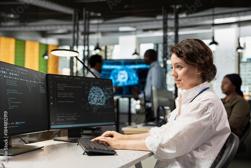 Bild auf Leinwand Computer scientist in artificial intelligence tech company workplace conducts code reviews