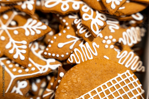 Canvas Print Close-up of beautifully decorated gingerbread cookies in various shapes, showcasing intricate white icing patterns