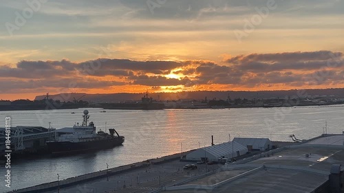 Sunset over San Diego Harbor with aircraft carriers in the distance