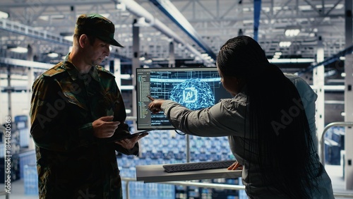 Server room army experts deploy AI tech to modernize defense infrastructure. Military server room colleagues enhancing tactical readiness by integrating artificial intelligence technology, camera B