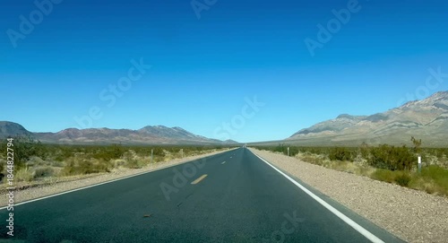 Driving down rural highway with mountain landscape