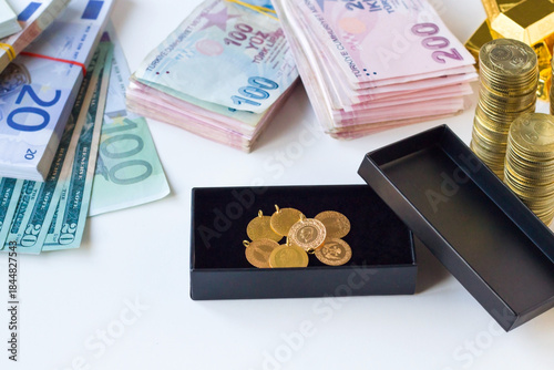 Photos Traditional Turkish Gold coins in box with dollar, euro and Turkish Lira banknot