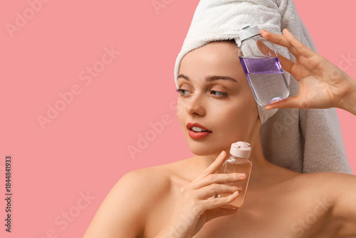 Young woman with bottles of...