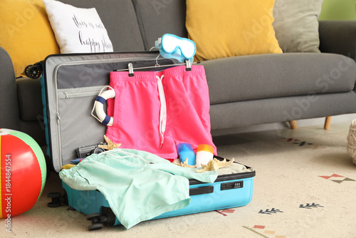 Open suitcase with men's sw...