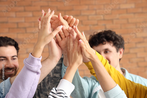 Young people putting hands ...