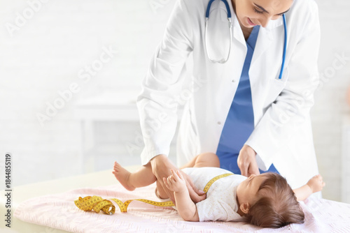 Female pediatrician measuri...
