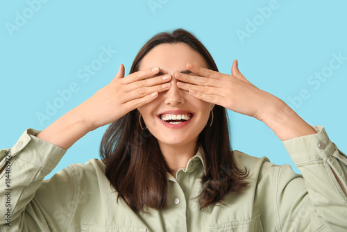 Smiling young woman closing...