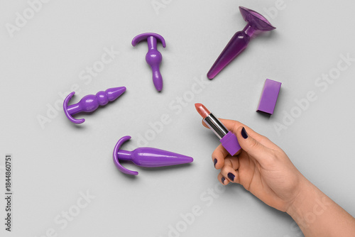 Female hand with lipstick a...