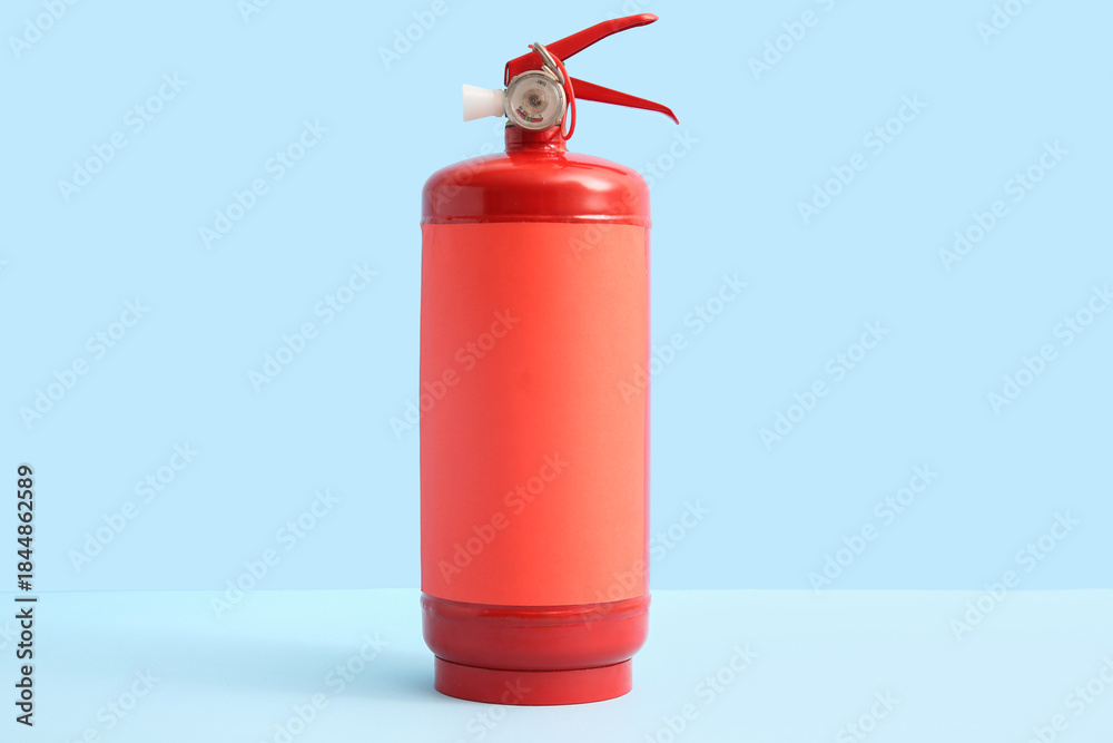 Obraz premium Fire extinguisher on blue background