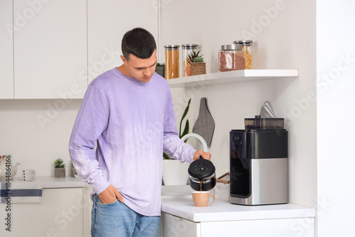 Handsome young man pouring ...