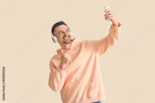 Happy young man in headphon...