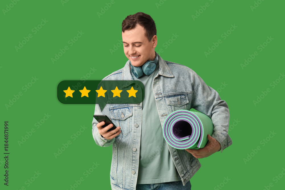 © Pixel-Shot - Young man with mobile phone and sleeping mat on green background. Travel concept © Pixel-Shot - Young man with mobile phone and sleeping mat on green background. Travel concept