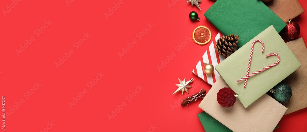 Naklejka premium Books and Christmas decorations on red background with space for text