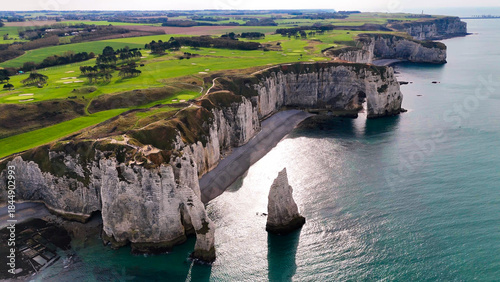 Aerial drone view of picturesque coastal limestone cliffs and the English Channel town of Etretat, France