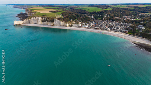 Aerial drone view of picturesque coastal limestone cliffs and the English Channel town of Etretat, France