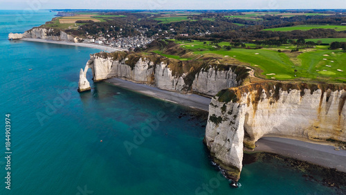 Aerial drone view of picturesque coastal limestone cliffs and the English Channel town of Etretat, France
