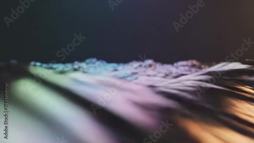 Abstract Metallic Wave - A close-up abstract video showcasing a flowing, glossy wave with metallic colors. The light reflects off the smooth surface, creating an interesting texture and visual effect.