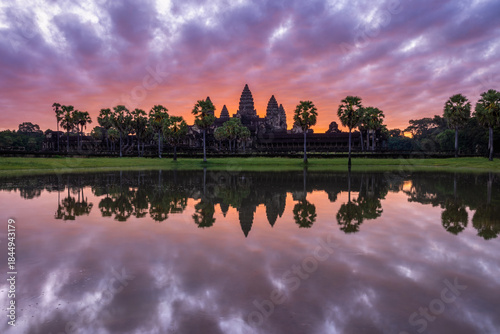Colourful sunrise through dramatic clouds at Angkor Wat in Cambodia