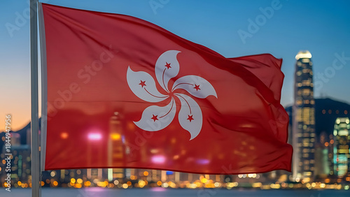 Hong Kong flag waving proudly over Victoria Harbour at dusk, city lights twinkling, creating a patriotic and inspiring scene.