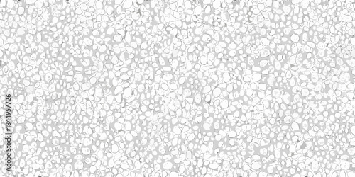 Close up view of a textured surface resembling small light colored pebbles