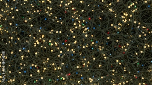 Photo of closeup of tangled, illuminated christmas string lights with warm white and colored bulbs on a dark background