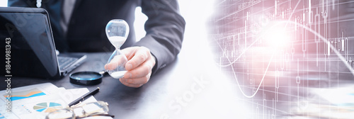 Working time symbolizes an hourglass. Office desk of insurance manager and banker. Office employee at the table. The concept of lack of time.