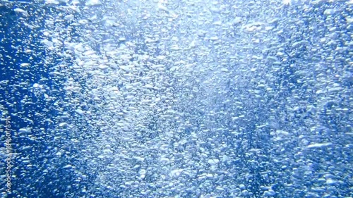 Ocean blue underwater with sunrays, Underwater Sea Deep Water Abstract Sunshine, sea wave , clean waters in summer time, Natural underwater seascape, sand on ocean floor and water surface with sunligh