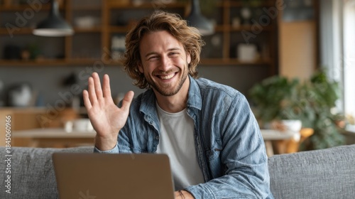 Wallpaper Mural Young Man Sitting on Sofa Waving While Video Calling at Home Torontodigital.ca