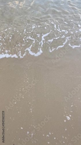 Wallpaper Mural Sea water washes ashore in hot summer day at the beach by the ocean or sea. Sandy coast as tide rolls in during vacation or holiday. Tourist filming pov point of view shot with ugc style phone camera Torontodigital.ca