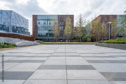 Modern Office Building Entrance with Glass Facade and Landscaped Walkway

