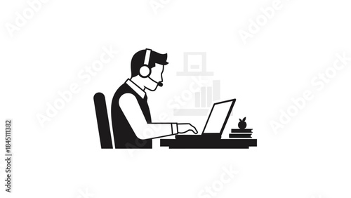 Man working on laptop with headset on.