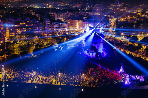 Fototapeta Naklejka Na Ścianę i Meble -  New Year’s Eve Gathering Around Thessaloniki White Tower with Festive Lights and Urban Energy