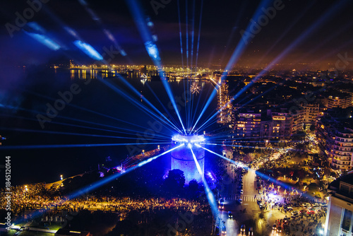 Fototapeta Naklejka Na Ścianę i Meble -  New Year’s Eve Gathering Around Thessaloniki White Tower with Festive Lights and Urban Energy